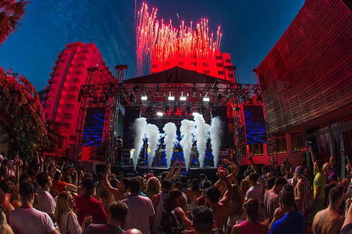 Concert crowd with fireworks and stage lights