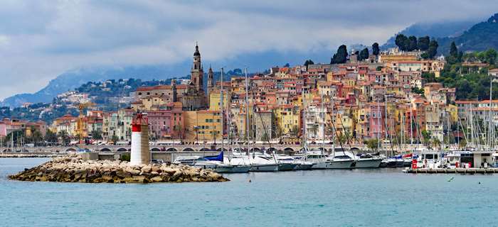 Menton harbor with lighthouse and colorful buildings, France
