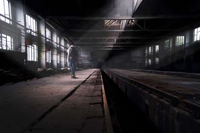 Boy on skateboard in abandoned factory 4K