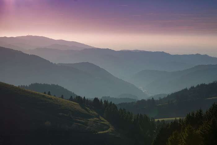 Misty mountains and hills at sunrise or sunset