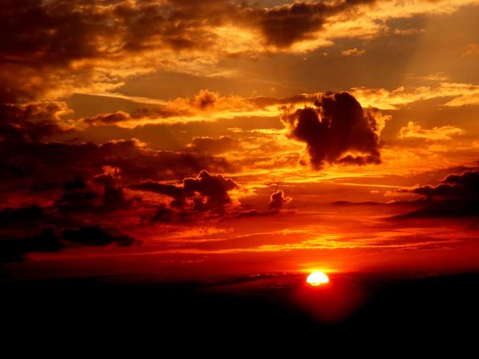 Dramatic sunset with fiery clouds and sun