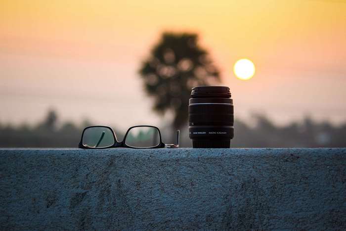 Camera lens and glasses at sunset 4K