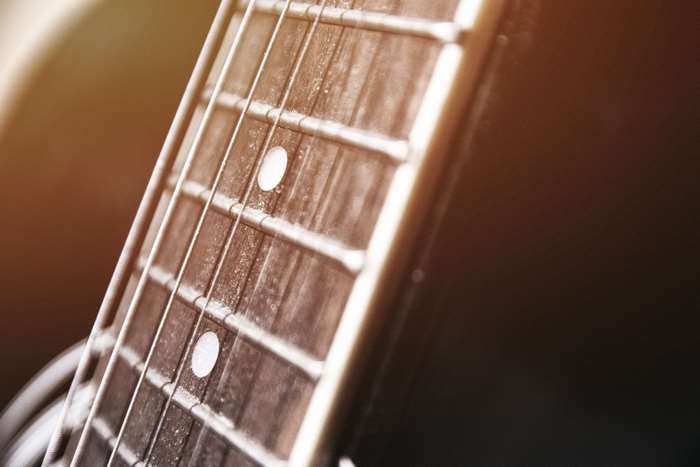 Close-up of an acoustic guitar fretboard