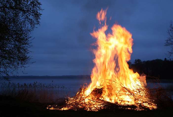 Bonfire by a lake at dusk