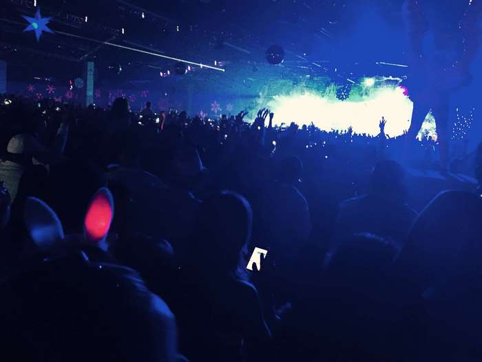 Crowd at a concert with blue and green lights