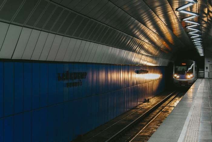 Subway station with train and blue walls