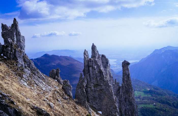 Jagged rocky peaks overlooking a blue valley and lake
