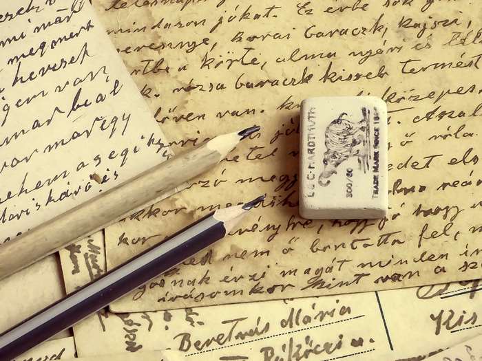 Handwritten letters with pencils and eraser