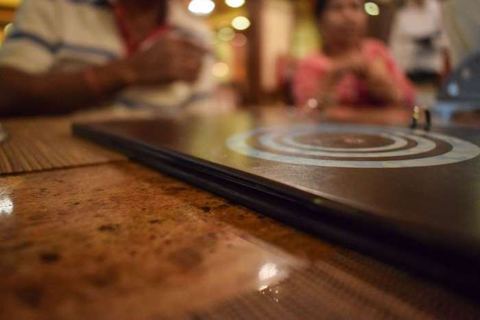 Restaurant table with menu and people