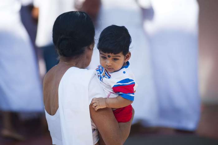 Woman holding a baby boy in India 4K