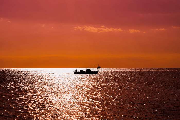 Boat on the sea at sunset in Cyprus