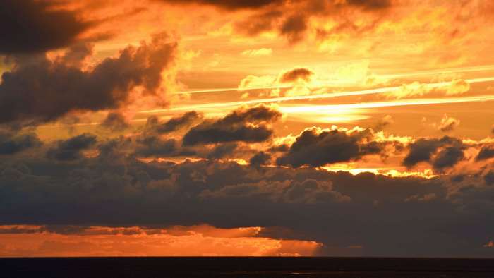 Sunset over the sea with dramatic clouds
