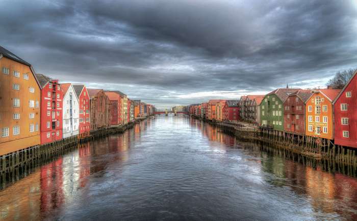Colorful buildings along a river in Trondheim, Norway