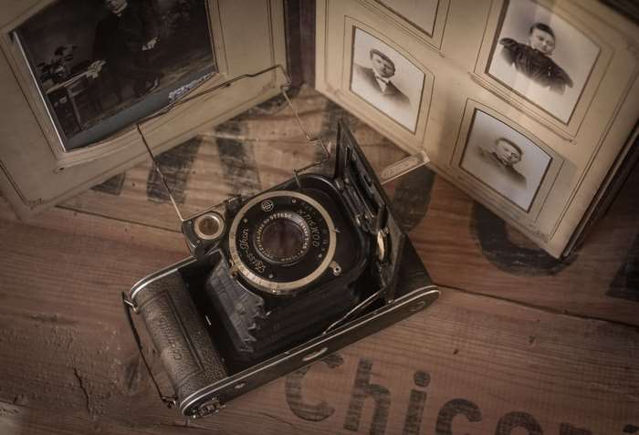 Vintage camera and photo album with old portraits