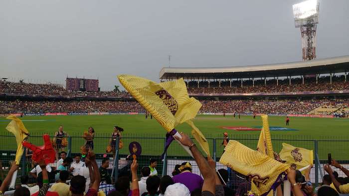 Cricket stadium with fans waving flags