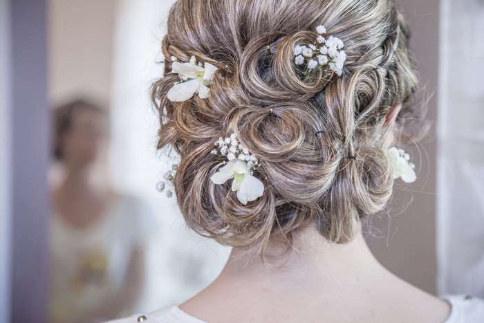 Woman with elegant braided updo and white flowers