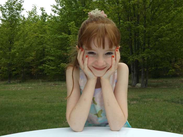 Cheerful Redheaded Girl Smiling Outdoors
