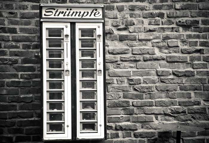 Vintage stocking vending machine on a brick wall