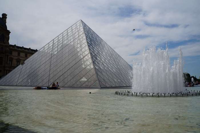 Louvre Pyramid and fountain in Paris, France
