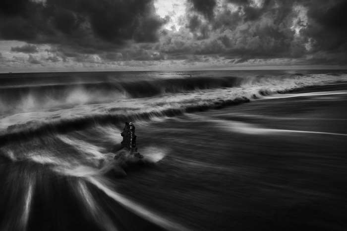 Black and white seascape with stormy clouds and waves