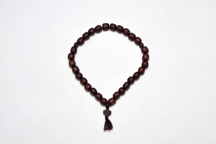 Wooden rosary with a cross and tassel