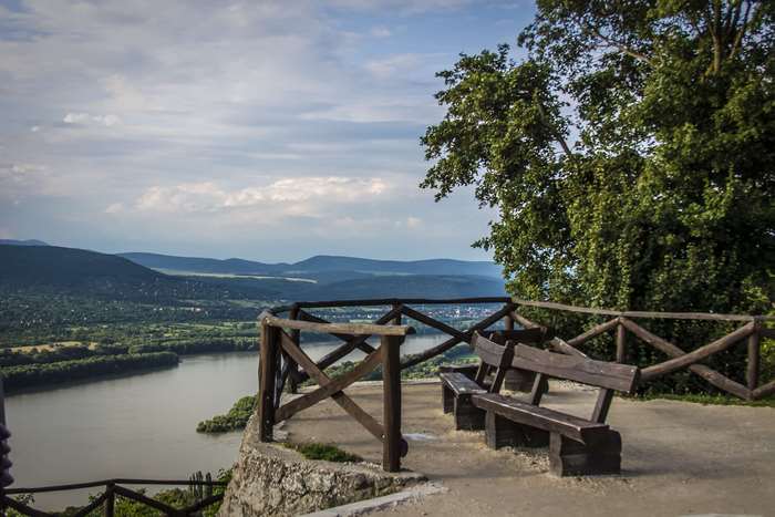 View from a scenic overlook with wooden benches and a river valley