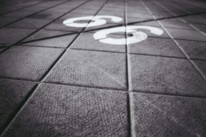 Number 66 on a tiled pavement