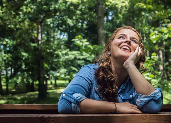Young woman smiling outdoors in a park