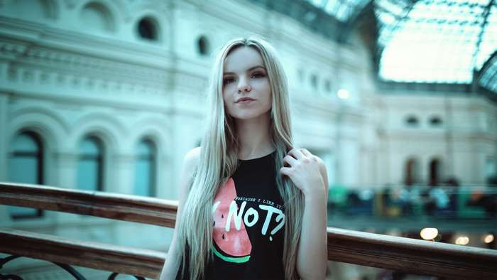 Young woman with blonde hair wearing a black t-shirt with a watermelon design