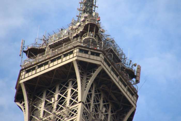 Eiffel Tower top with antennas and blue sky