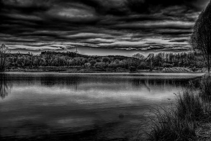 Black and white landscape with lake and dramatic clouds