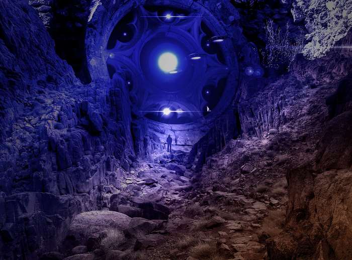 Man in cave with alien spaceship overhead