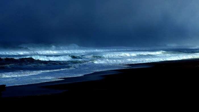 Stormy Pacific Ocean waves crashing on a dark beach 4K