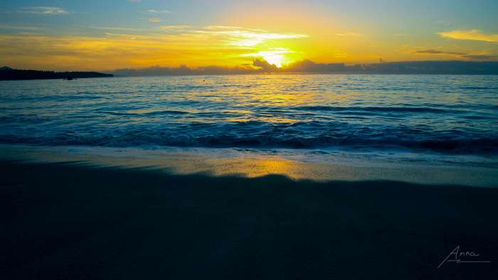 Beach at sunrise with ocean waves