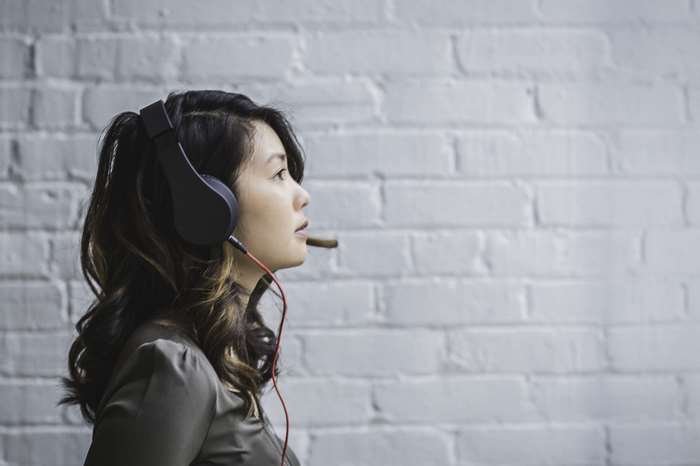 Woman wearing headphones and smoking a cigar