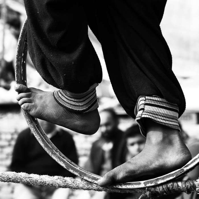 Child balancing on a wheel in India