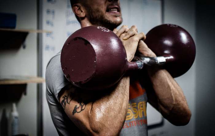 Man performing kettlebell rack position exercise