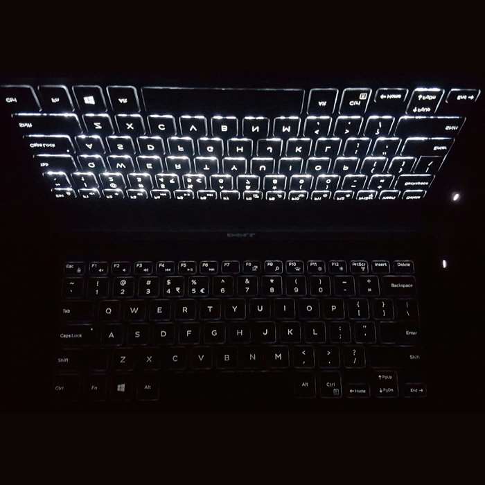 Illuminated laptop keyboard at night
