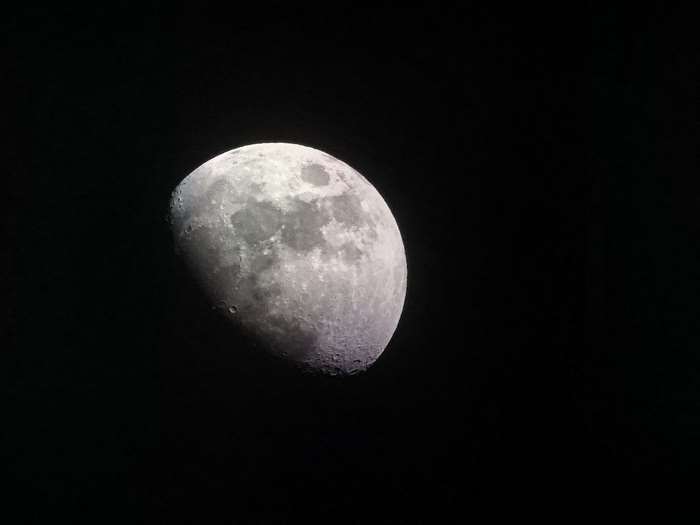 Bright Half Moon with Lunar Craters at Night
