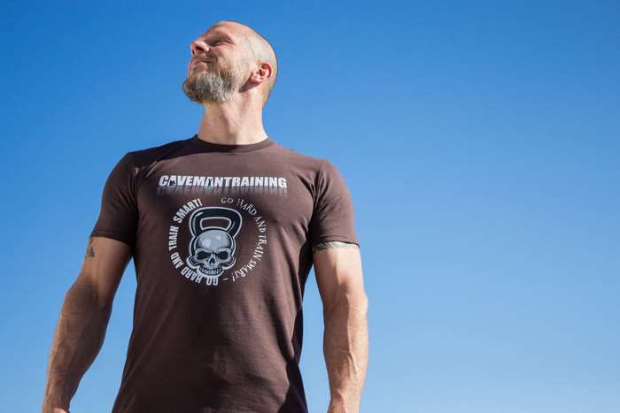 Man wearing a Caveman Training t-shirt