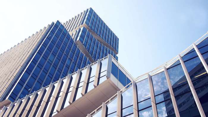 Modern glass skyscrapers against a clear blue sky