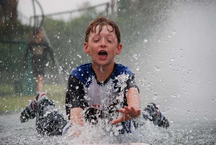 Boy playing in water spray