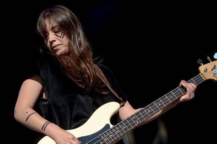 Woman playing a bass guitar on stage