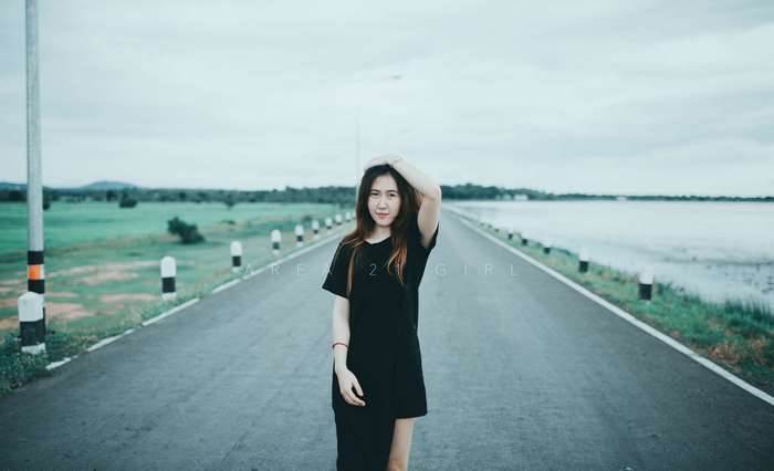 Girl on a road with a lake