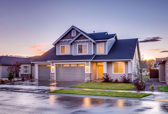 Modern suburban house with garage at dusk