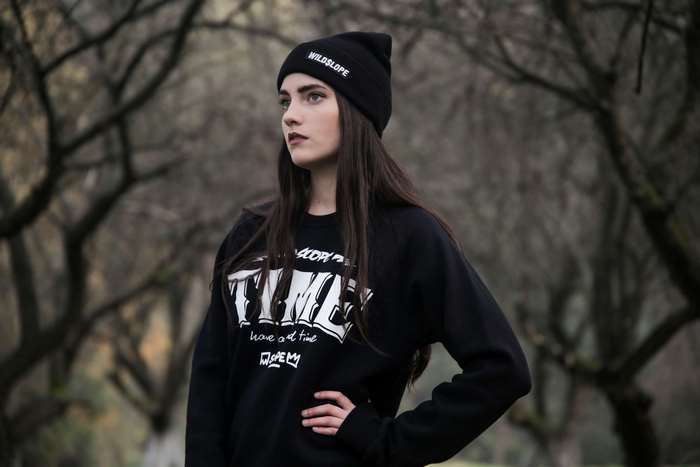 Young woman wearing a beanie and sweater outdoors
