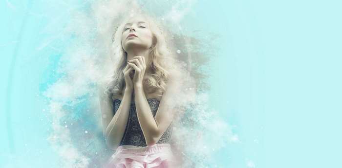Woman praying with ethereal light and smoke