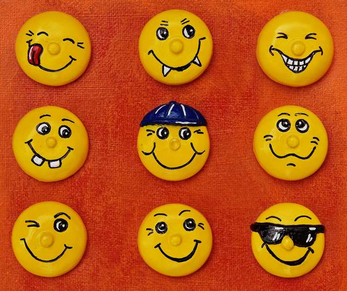 Nine yellow smiley faces with different expressions