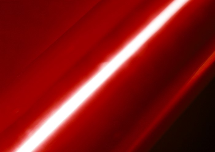 Red surface with a bright diagonal light streak