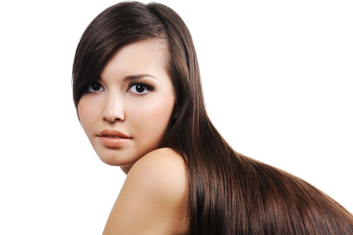 Brunette girl with long dark hair on white background
